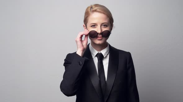 businesswoman in a classic business suit and sunglasses