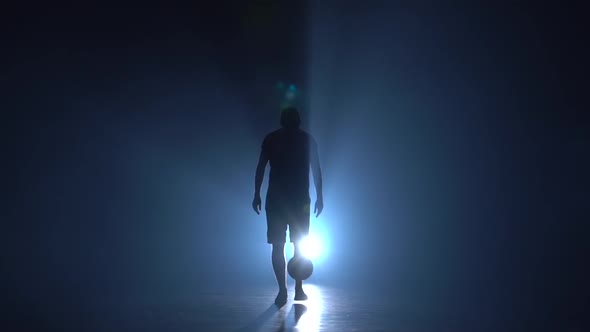 Young Player Stuffing Ball on Feet in Studio. Slow Motion