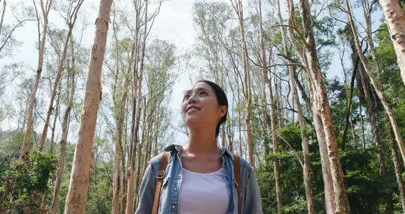 Woman look at the forest in hiking trail