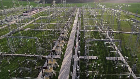 High voltage electrical substation. View from flying drone. Power plant with tall pylons.