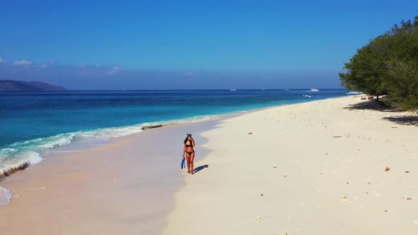 Beautiful ladies posing on paradise coastline beach journey by blue sea with white sand background o