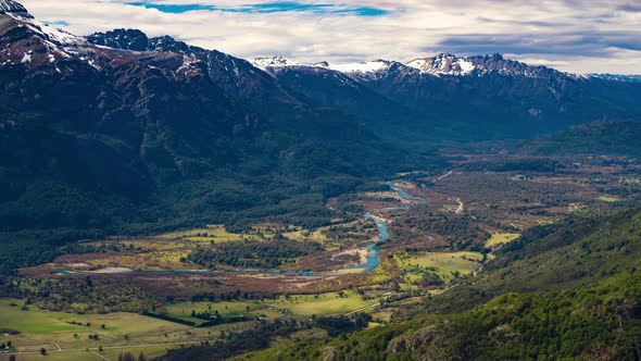 Timelapse video. Top shot of Manso river surrounded by native forests and mountains. Shot in 4k.