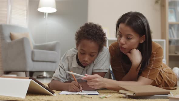 Mom and Son Studying on Floor