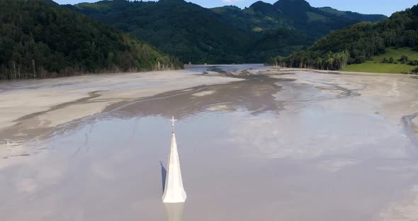 Church Spire Of The Sunken Geamana Village At The Middle Of The Toxic Lake