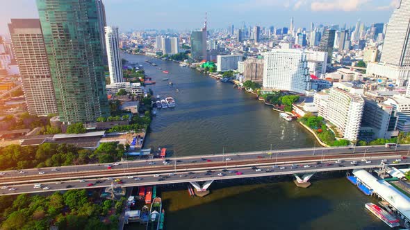 4K : Drones fly over the Chao Phraya River, buildings and business districts in Bangkok