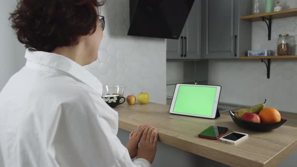 Woman Talking to Digital Tablet Webcam Green Screen Laughing and Smiling on Video Conference