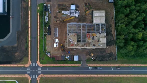 Flying above construction site with machinery, drone footage