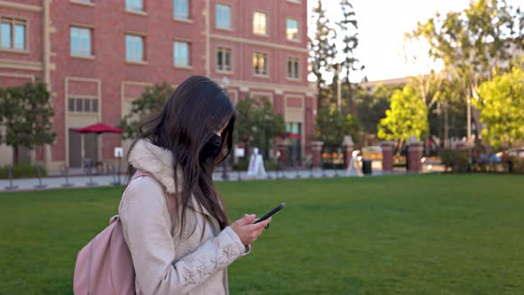 Asian female college student walking  to her class