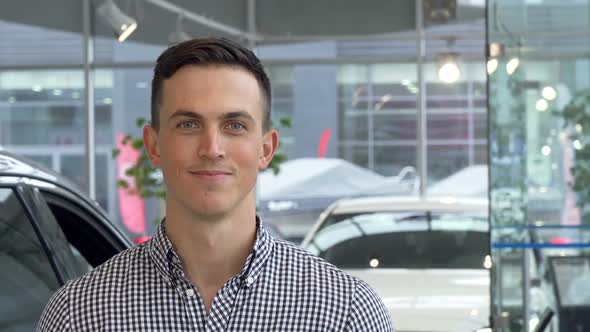 Happy Male Customer Showing Thumbs Up Holding Car Keys at the Dealership 1080p