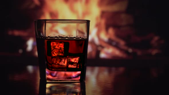 Glass of Alcohol Near the Fireplace