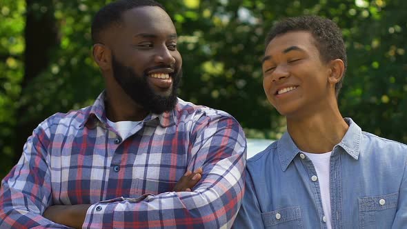 African-American Father and Son Looking to Camera and Smiling, Happy Family