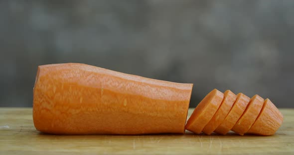 Chopping Carrot Close Up on Wooden Board