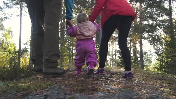 American Young Family with Child Walking in Forest on Autumn Day