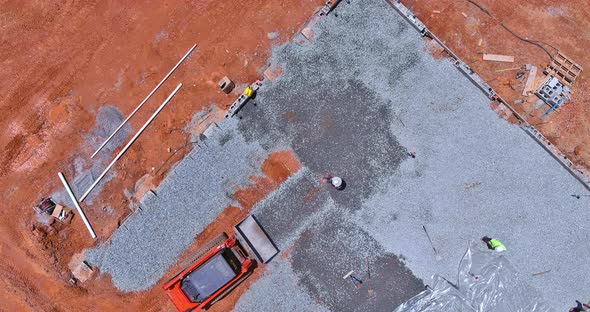 An Excavator Bucket is Used to Level Gravel on a Construction Site in Order to Level