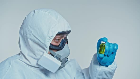 Doctor Protection Suit Holding Vaccine Ampoule Hand Closeup