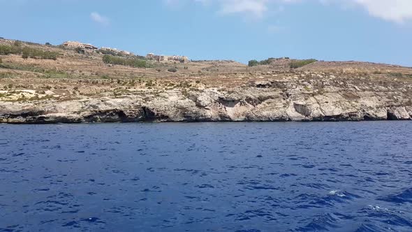 A day view of one of the islands of Malta, with the mediterranean water on a sunny summer day. Trave