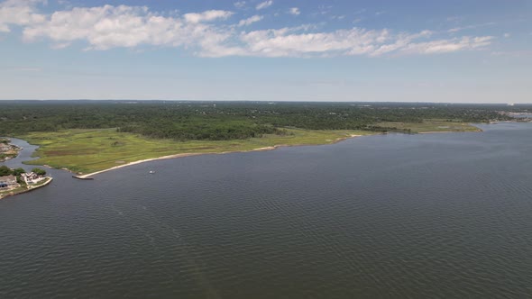 A high angle view over the Great South Bay on a sunny morning with blue skies and white clouds. The