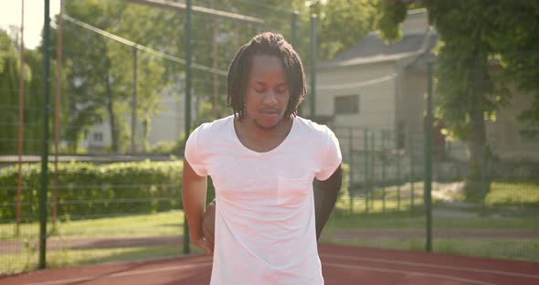 African American Man Does a Warmup Before Playing Basketball