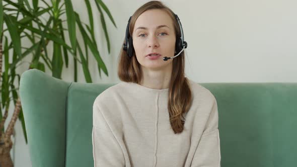 Smiling Young Woman in Headphone Speak Talk on Video Call at Home Web Conference Concept