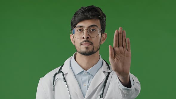 Young Male Doctor Man in Medical Mask Isolated in Green Chroma Key Studio Show Stop Sign with