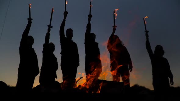 Men Holding Fire Torches