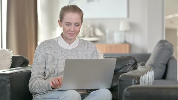 Successful Woman Celebrating on Laptop at Home 