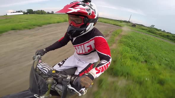 motocross rider giving rock on devil horns sign over jump selfie gopro