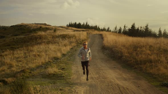 Fit Guy Running Marathon in Mountain Landscape