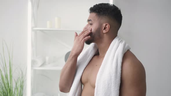 Skin Care Facial Treatment Man Applying Face Cream