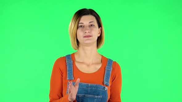 Girl Claps Her Hands Indifferently. Green Screen