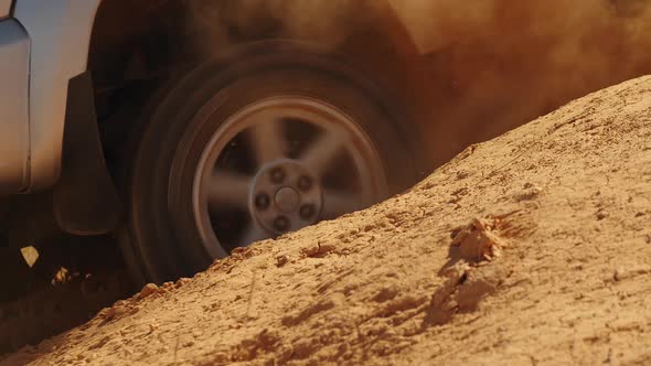Closeup of an SUV Wheel Skidding in Hole on Off Road Side View