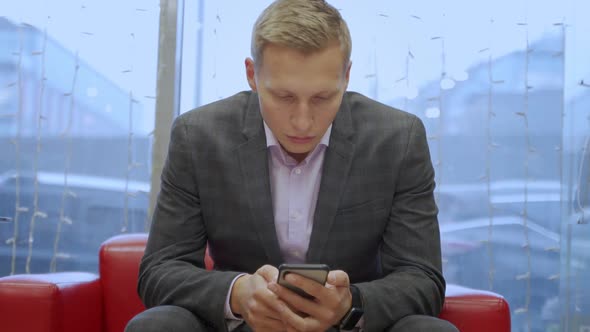 A Handsome Young Businessman Using His Phone