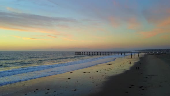 Aerial drone view of a sunset at the beach over the ocean.