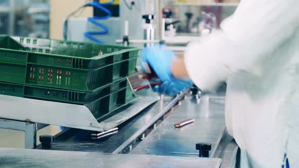 Factory Worker Is Putting Sweets Into the Conveyor Machine