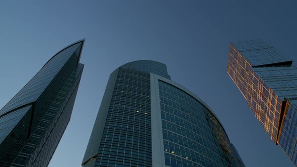 Gimbal Shot of Three Skyscrapers on Background of Blue Sky