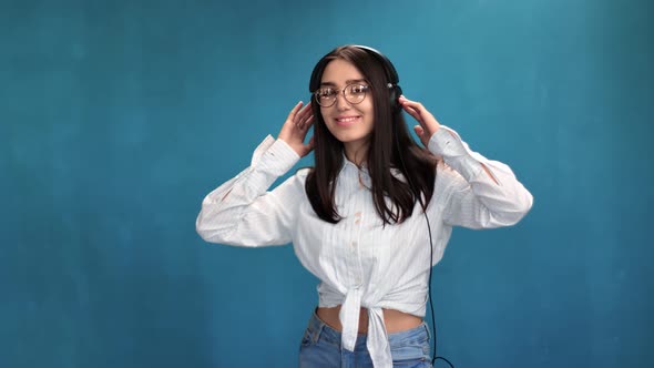 Seductive Trendy Girl Dancing Enjoying Sound at Headphones Isolated