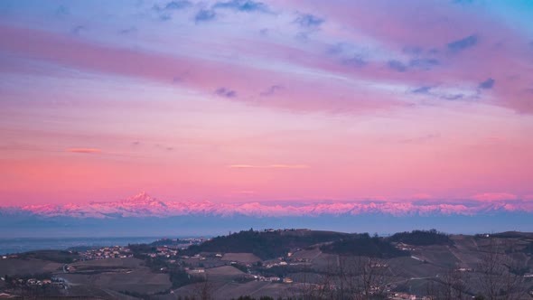 Time lapse: the Alps at sunrise view from Langhe wine yards region, Italy