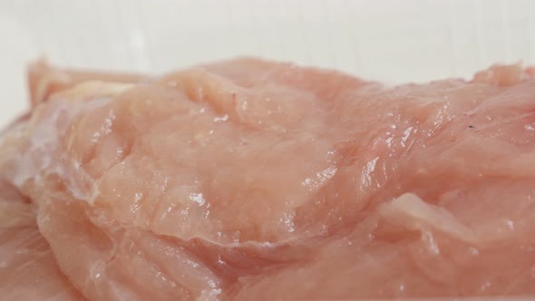 Fresh poultry meat 4K 2160p 30fps UltraHD  panning video - Raw chicken breasts in a box close-up slo