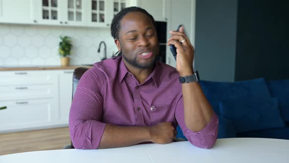 AfricanAmerican Guy Enjoy a Phone Conversation with Friend or Family