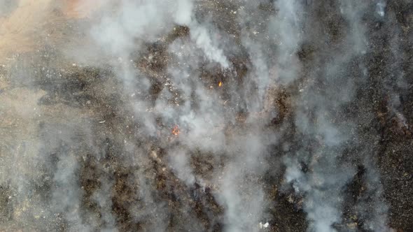 Aerial top down view landfill site caught fire.