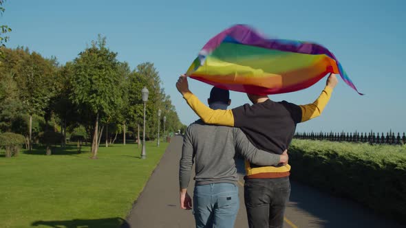 Homosexual Couple with Lgbt Flag Strolling Outdoor