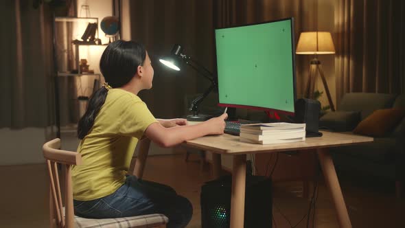 Asian Girl Learning Online From Home, Raising Hand Distance With Mock Up Computer Green Screen