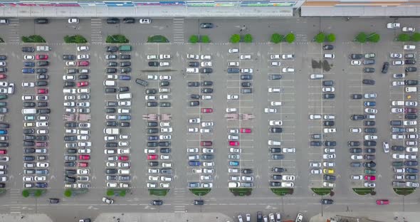 Beautiful Aerial side fly right to left view on a huge parking lot near the shopping mall