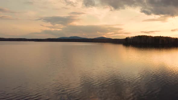 Aerial View of the Natural Landscape Forest on the Lake Shore at Sunset