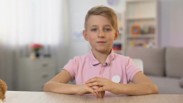 Boy Tasting Ice-Cream Cone From Female Hand Sitting at Table, Childhood Dessert