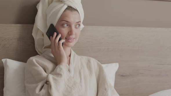 Woman Making Phone Call in Bed