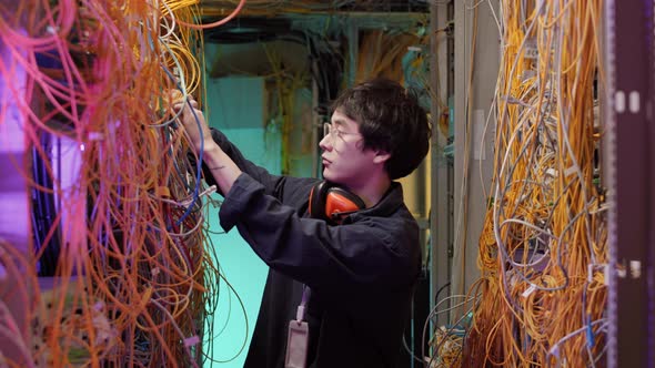 Young IT Technician Checking Server Wires