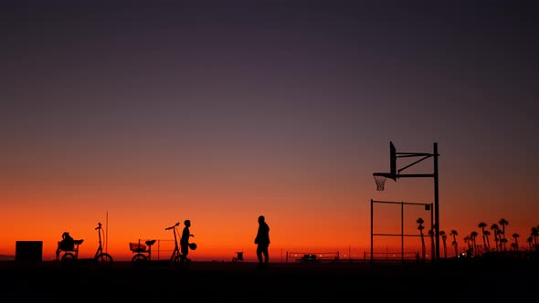 California Summertime Dusk Beach Aesthetic, Pink Sunset. Unrecognizable Silhouettes, People Play