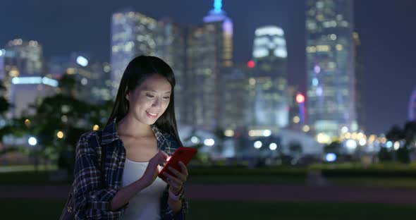 Woman Use of Mobile Phone in City at Night