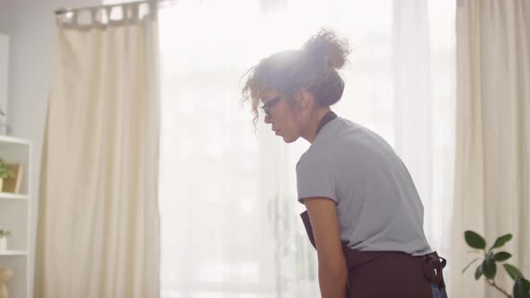 Young Woman Mopping Floor